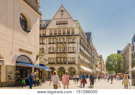 MUNICH GERMANY - JUNE 7 2016: View of the pedestrian street of Neuhauser in centre of Munich. Bavaria Germany.