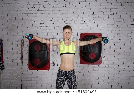 Young Woman Goes In For Sports At Gym