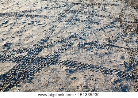 Wheel tracks on the wet sand after the rain