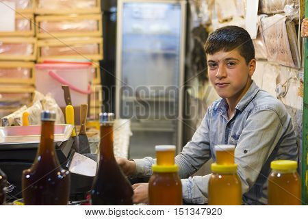 Ardabil- IRAN-September 21 2016 Happy Teenager Seller Assistant in Honeycomb Store