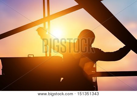Silhouette Mechanical Engineer Check the machine before starting work to ensure the safety of workers over the machine will blur and colleagues.