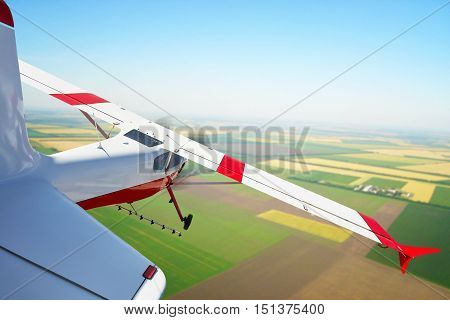 The plane sprays farmers' fields, the plane flies over the ground, aviation in agriculture