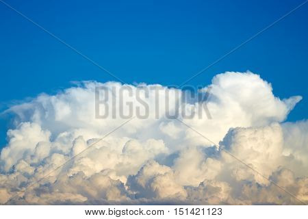 Big white cumulus clouds on a blue sky
