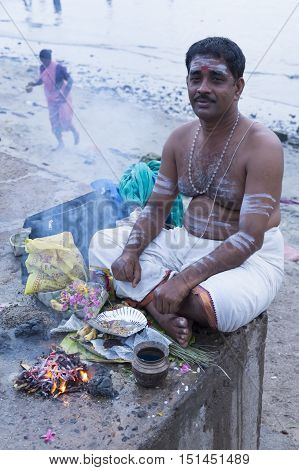 Rameswaram, Tamil Nadu, India - May 25, 2014. Full report about Rameswaram pilgrimage, religion. Religious city rituals. Priest on the beach side, offerings, prayer