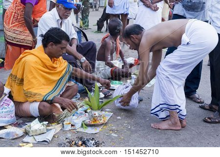 Rameswaram, Tamil Nadu, India - May 25, 2014. Full report about Rameswaram pilgrimage, religion. Religious city rituals. Priest on the beach side, offerings, prayer