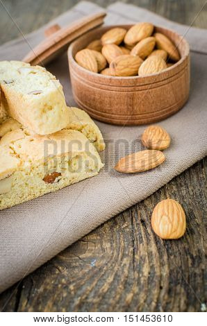 Italian cantuccini cookies with almonds. Traditional italian almond cookies biscotti on old wooden background. Homemade Almond cookies on wooden table. Delicious cookies biscotti. Selective focus.