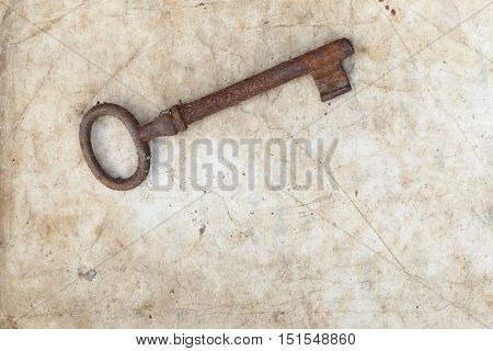 Detail of the rusty key on old parchment