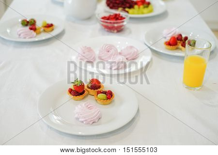 Bowl with berries on the table in kitchen