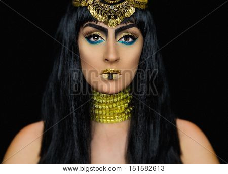 Cleopatra halloween makeup with a caucasian girl posing in the studio
