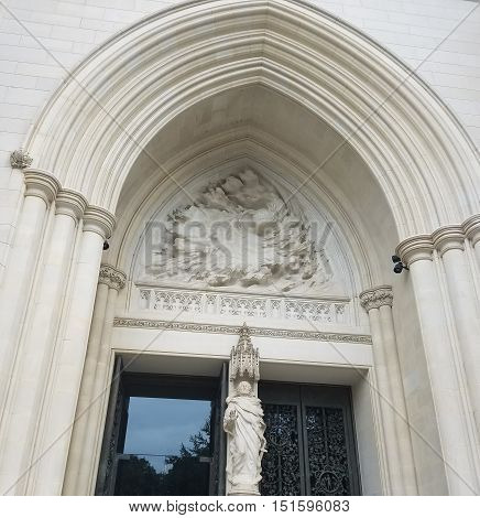 Washington DC, USA - September 17, 2016 - The portal of the Cathedral Church of Saint Peter and Saint Paul in the City and Diocese of Washington, known as The National Cathedral, with architectural and sculptural neo-Gothic details.