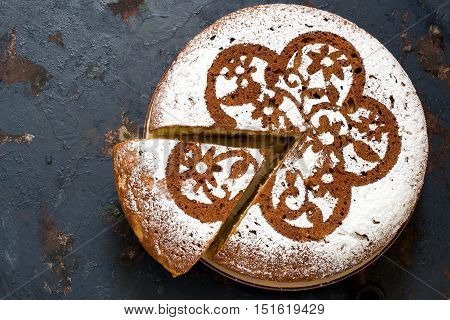 Baking in multicooker. Delicious homemade cake with cottage cheese and chocolate pieces on a dark iron textured surface