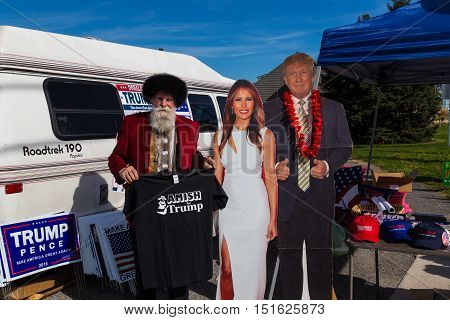 Ronks PA USA - October 11 2016: Standing with cutouts of Donald Trump and his wife a vendor holds Amish for Trump shirts for sale in Lancaster County.