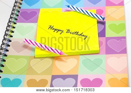 Happy birthday candle and notepad with love diary background