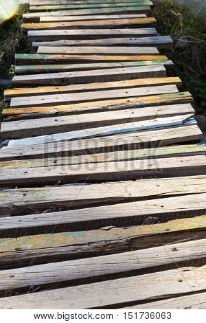 old wooden bridge of planks over the river