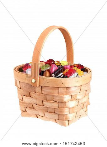 Basket filled with asorted candy isolated on white background