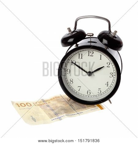 A black alarm clock with happy face on a one hundred Kroner Danish money banknote isolated on white background.