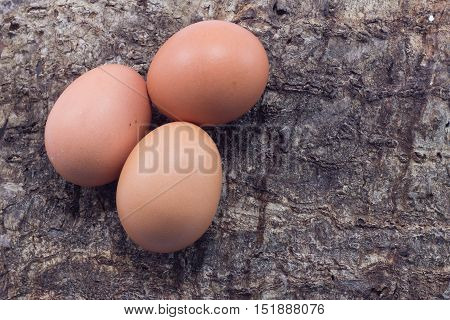 Three eggs on Woodenbackground. Top view. .