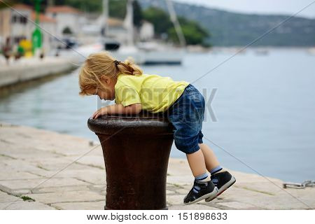 Boy Climbs On Bitt