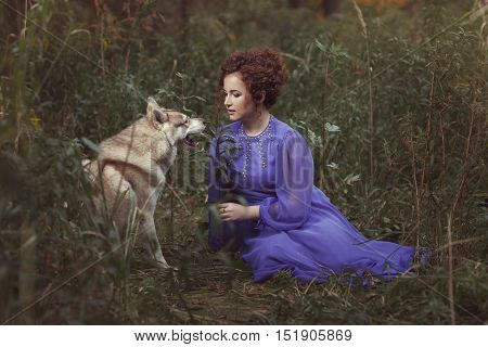 Girl talking with a dog in the fairy forest.