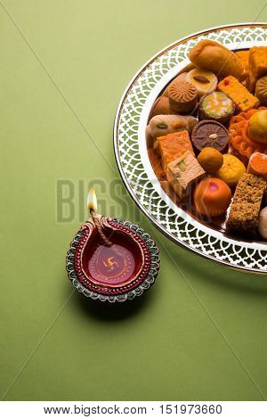 Mix Mithai and diya on diwali festival