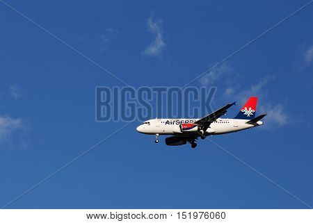 Marsta, Sweden - July 6, 2016: An Airbus A319-132 (YU-APB) in service with Air Serbia on approach to Stockholm Arlanda Airport with deployed landing gear.