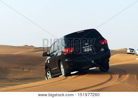DUBAI UAE - SEPTEMBER 12: The Dubai desert trip in off-road car is major tourists attraction in Dubai on September 12 2013 in Dubai UAE