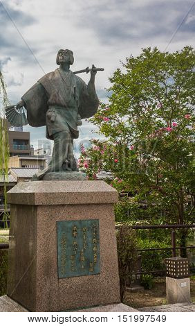 Kyoto Japan - September 16 2016: Izumo No Okuni statue at crossing of river and Gion neighborhood. She is the founder of the Kabuki dance at the start of 17th century.