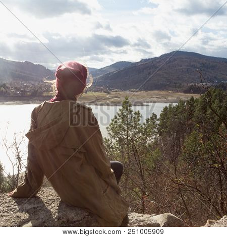 Girl Hipster Sits On The Background Of Romanian Carpathians Mountains