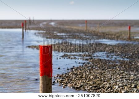 Wooden Piles With Red Tips Mark The Way Through The Mud Flats, Nordstrand, Schleswig-holstein, Germa