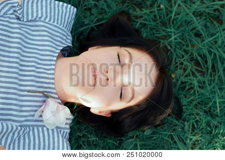 Beautiful Girl With Dark Hair And Different Eye Color Heterochromia . Smiles At The Photos In The Pa