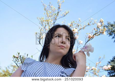 Beautiful Girl With Dark Hair And Different Eye Color Heterochromia . Smiles At The Photos In The Pa