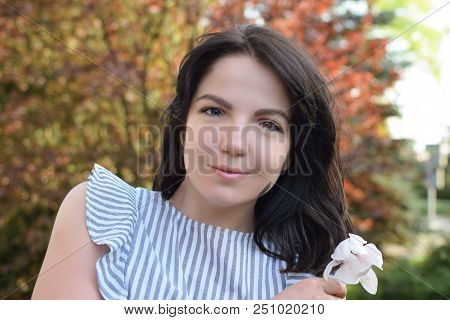 Beautiful Girl With Dark Hair And Different Eye Color Heterochromia . Smiles At The Photos In The Pa