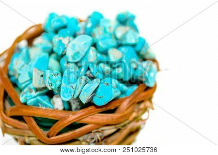 Pile Stones Of Raw Turquoise In Small Wooden Nest On A White Background. Blue And Green Color Stones