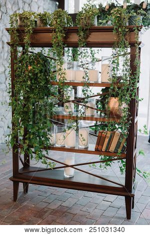 The Wooden Bookcase For Books With A Set Of The Hanging Greens. Elegant Details Decoration Of A Wedd