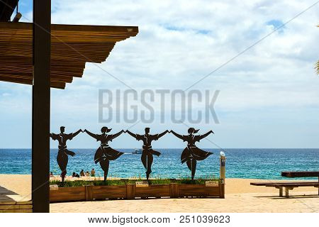 Blanes, Spain - 30 May, 2018: Monument To Sardana. Sculptural Composition With Dancing People. Sea W