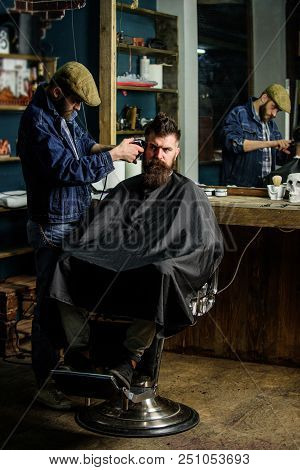 Hipster Client Getting Haircut. Barber With Clipper Trimming Hair On Temple Of Client. Barber With H