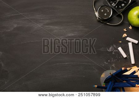 School Supplies, Alarm, Pencils, Apple On Black Chalkboard Top View, Copy Space. Concept: Back To Sc