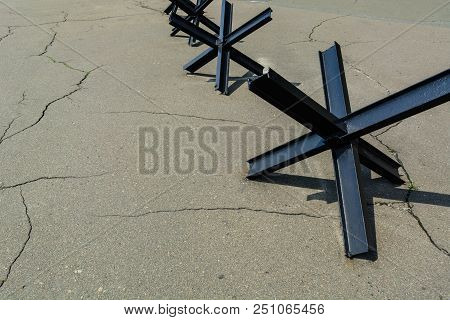 Anti-tank Barrage From Rails On Cracked Old Asphalt. Against War And Violence. Copy Space.