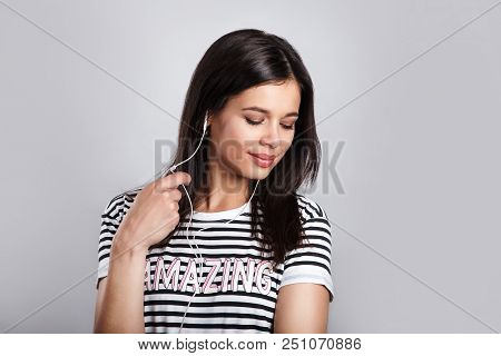 Young Stylish Pretty Womant Listening Music With Headphones And Smart Phone Hand Hold