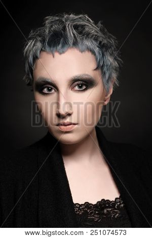 Close-up Portrait Of Beautiful Girl With Short Painted Blue Hair In Eyeglasses On Black Background. 