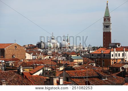 Very Tall Bell Tower Of Basilica Saint Mark In Venice Italy And More Roofs