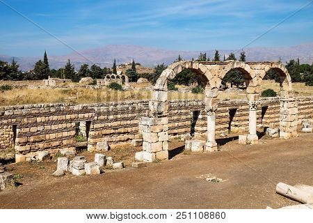 Arches In Umayyad City Ruins In Anjar With Mountains, Bekaa Valley, Lebanon