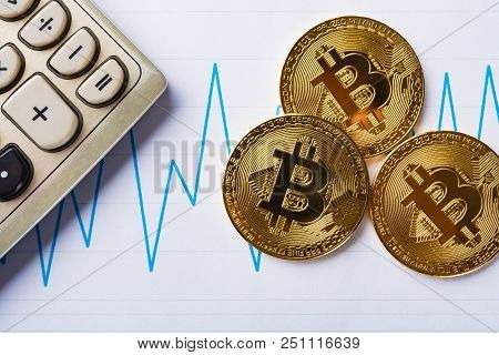 Bitcoins And Caculator On A Chart As Financial Concept