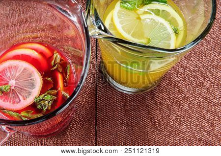 Yellow And Red Summer Lemonade Topped With Lemon.