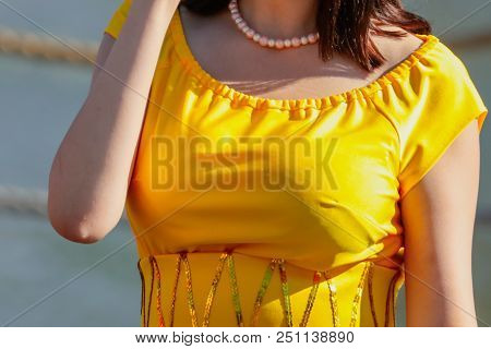 Chest Of A Girl In A Yellow Dress .