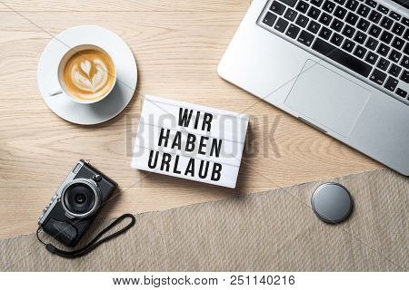 Wir Haben Urlaub Written In German On Light Box Meaning Closed For Holidays As Flatlay From Above Of