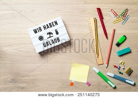 Wir Haben Urlaub Written In German On Light Box Meaning Closed For Holidays As Flatlay From Above Of
