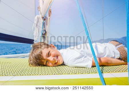 Cute Boy On Board Of Sailing Yacht On Summer Cruise. Travel Adventure, Yachting With Child On Family