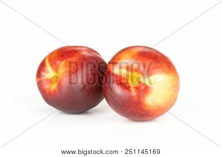 Group Of Two Whole Ripe Deep Red Nectarine Isolated On White