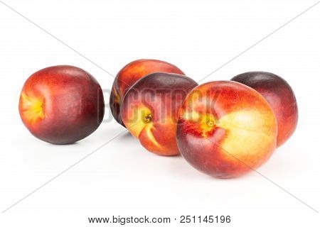 Group Of Five Whole Ripe Deep Red Nectarine Stack Isolated On White